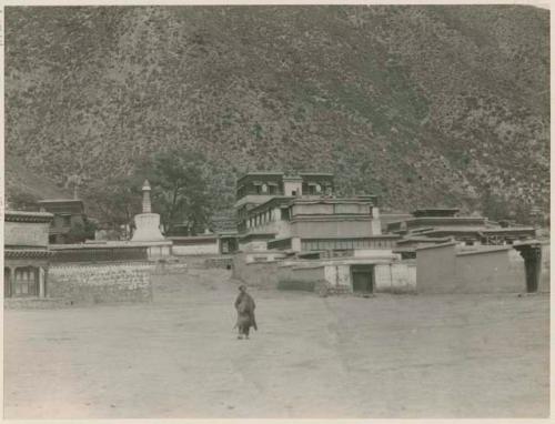 Temple building with person and white stupa, Labrang, Tibet