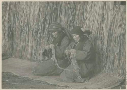 Woman preparing bark fiber for weaving