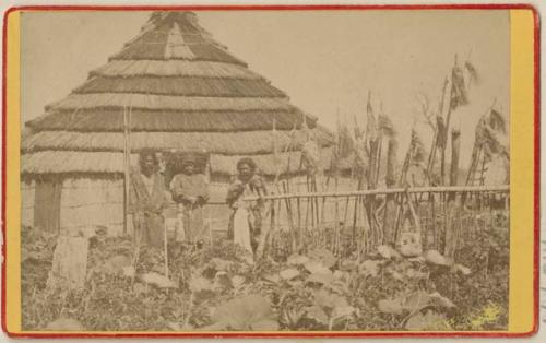 Men in front of hut