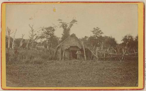 Man in front of hut