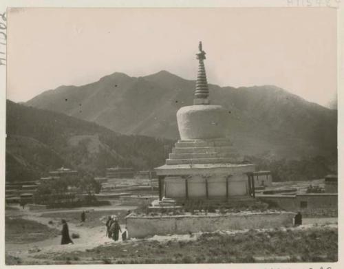 White stupa with people visible around it