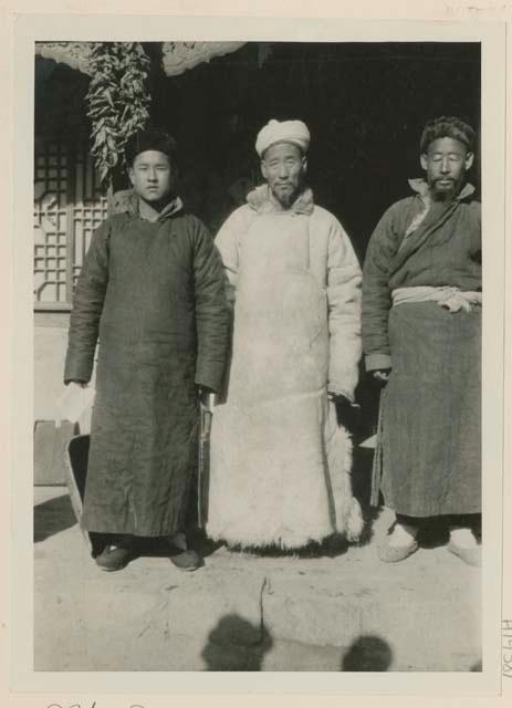 Three Muslim men standing outside