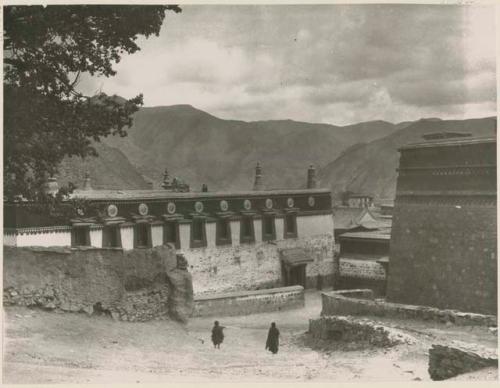 Temple building at lamasery with two people standing outside