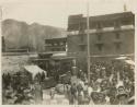 People, animals, and stalls outside in temple market