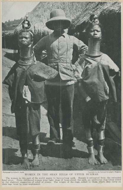 Two women wearing neck rings and man in western dress