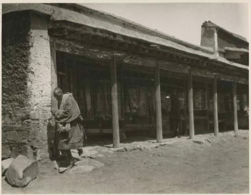 Pilgrims turning prayer wheels at temple