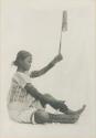 Tingian woman spinning cotton