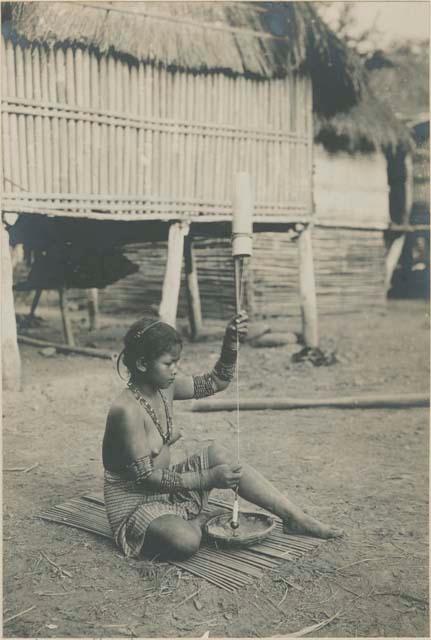 Tinguian woman spinning cotton