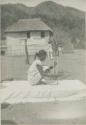Tinguian woman winding cotton thread on a reel