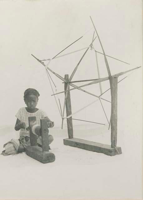 Young Tinguian girl skeining thread