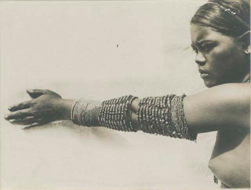 Wealthy Tinguian girl showing arm ornaments