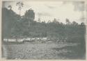 People poling canoes over rapids