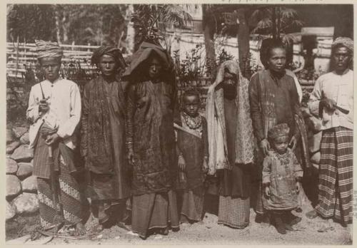 Posed line of adults and children, one carrying sword