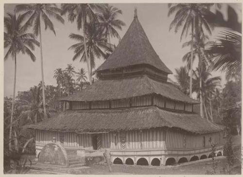 Tiered thatched building on stilts