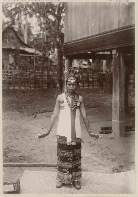 Woman with long fingernails and ornate headdress