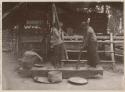 Women with large mortar and pestles