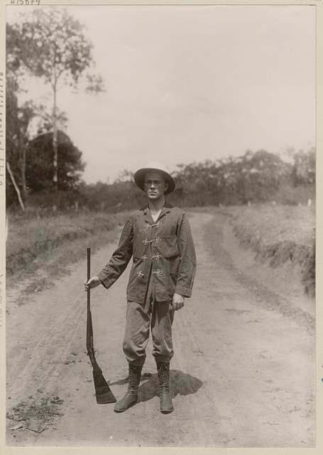 Man with gun standing in road