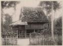 Building (house) surrounded by a fence