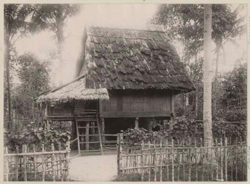 Building (house) surrounded by a fence