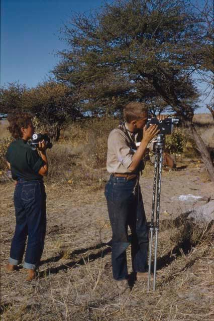 Elizabeth Marshall Thomas holding a camera and John Marshall filming