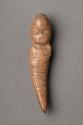 Small carved bone figure, pointed at one end