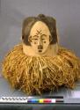 Ceremonial wooden mask with feather topknot