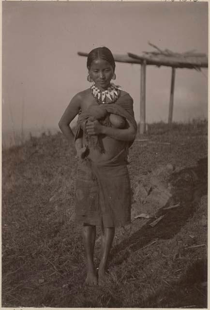 Woman carrying a child on her back