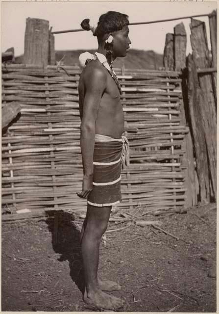 Man standing in front of a fence