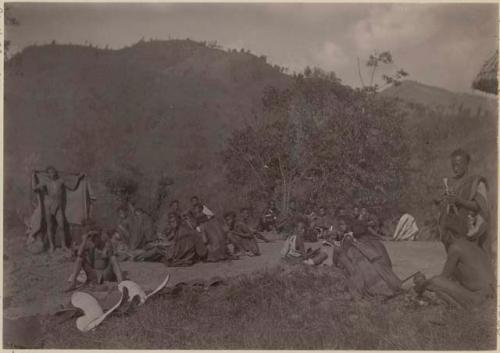 Group sitting along a road