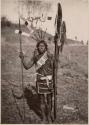 Man standing and holding spears