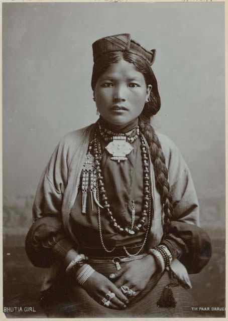 Studio portrait of a young woman in ornate jewelry