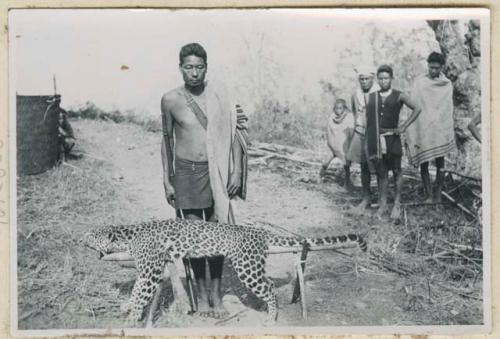 Man with dead leopard