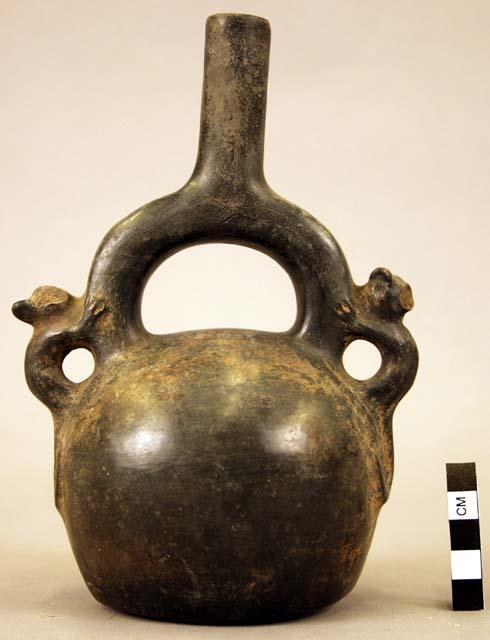 Pottery jar mouth in center of cross handle, animals on side