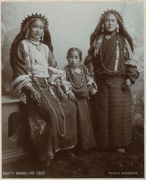 Studio portrait of two women and girl in ornate jewelry