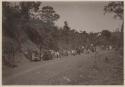 Large group of people seated along path