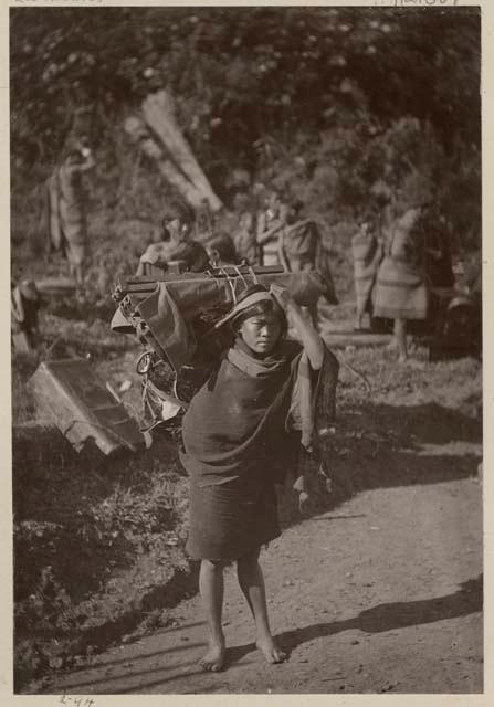 Woman with loaded basket on her back