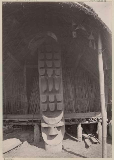 Carved post in front of morang