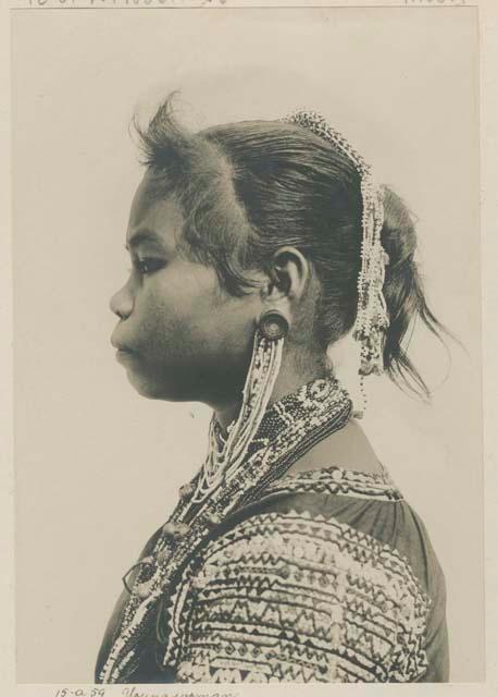 Bagobo woman wearing traditional clothing and jewelry, profile