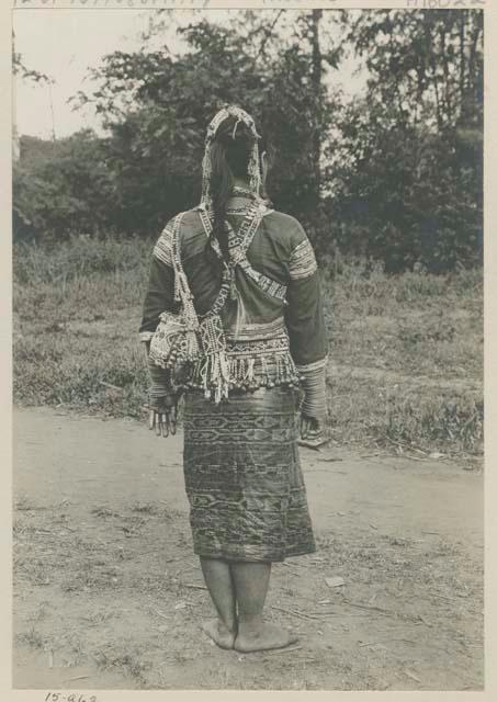 Bagobo woman wearing traditional clothing and jewelry, back