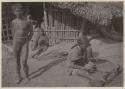 Man, child, and woman with string on her feet