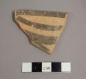 Ceramic rim sherd with painted bands on interior and exterior