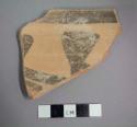 Ceramic rim sherd with painted band on exterior and painted geometric design on interior