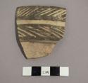 Ceramic rim sherd with painted band on interior and painted geometric design on exterior
