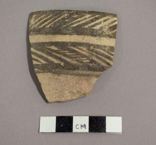 Ceramic rim sherd with painted band on interior and painted geometric design on exterior