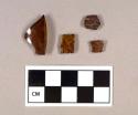 Glass, amber bottle glass fragments; one has mold seam; one is threaded bottle finish