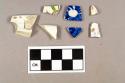 One molded pearlware rim sherd; one pearlware rim sherd; two blue hand painted whiteware body sherds; one green and brown handpainted whiteware body sherd; one blue transfer printed whiteware body sherd; one gold hand painted overglaze porcelain sherd, appears to be the ear of an animal figurine