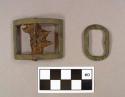 Buckle, copper alloy; one oval stock frame, undecorated; one rectangular shoe buckle with iron pin and prongs