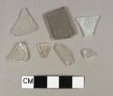 Glass fragments including clear bottle glass and flat glass that is both gray and clear