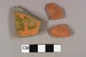 One redware base sherd; one lead glazed redware body sherd with mostly gray paste; one red stone fragment