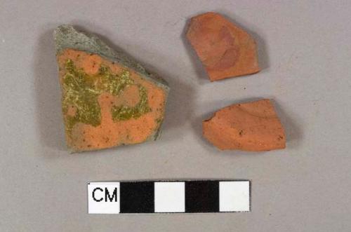 One redware base sherd; one lead glazed redware body sherd with mostly gray paste; one red stone fragment